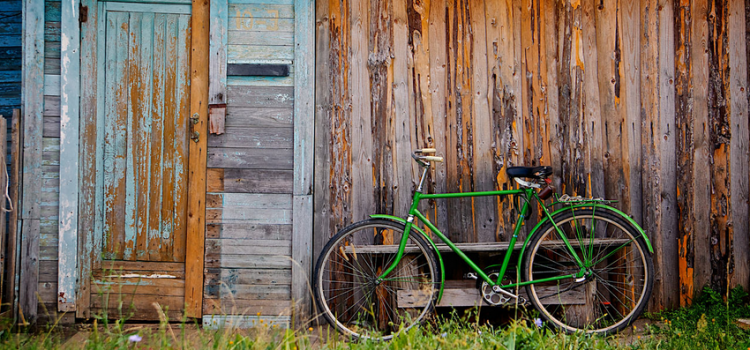Old wooden wall and green bicycle Old wooden wall and green bicycle